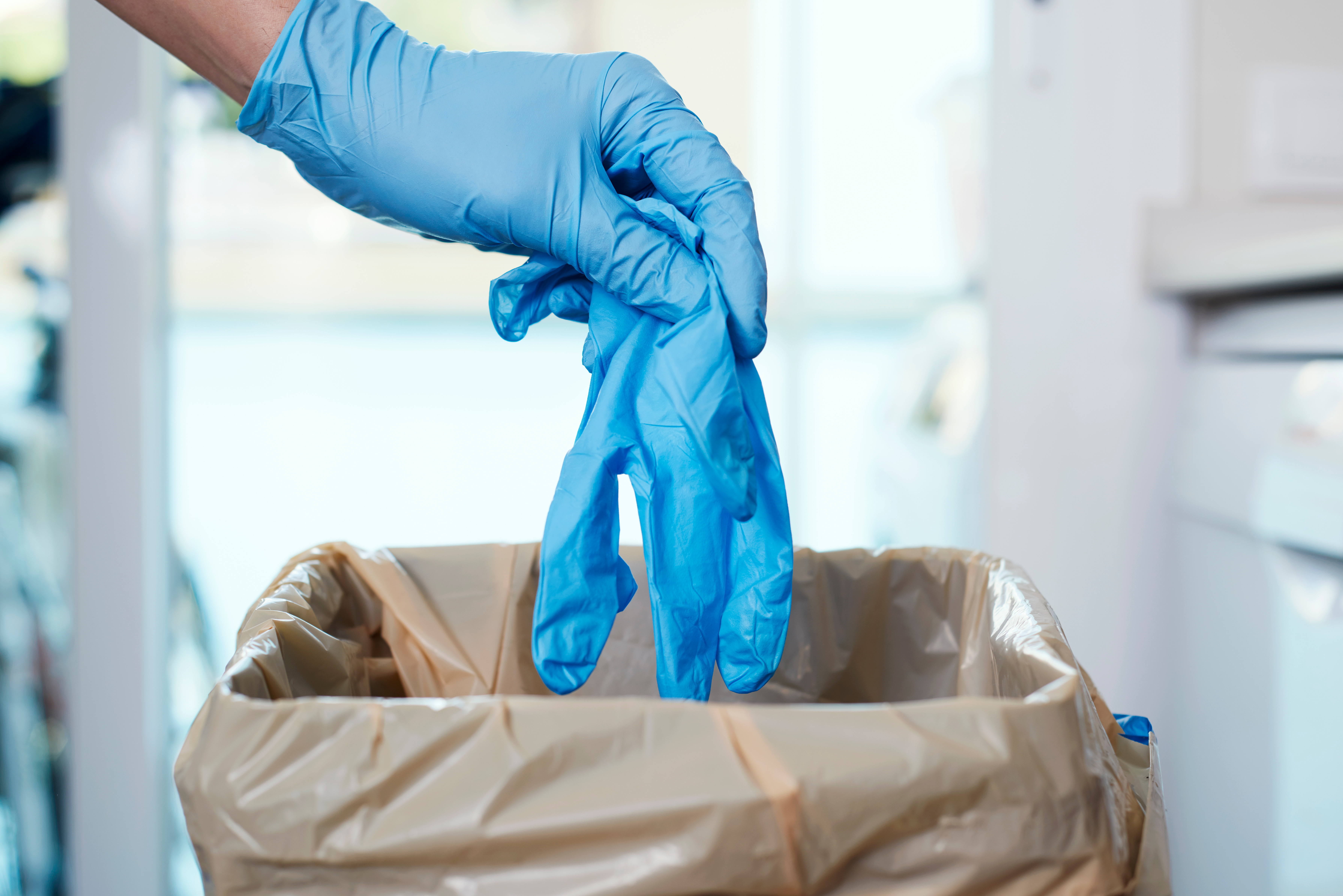 latex gloves to the trash can glove healthcare waste